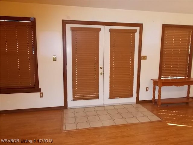 foyer featuring hardwood / wood-style flooring and french doors