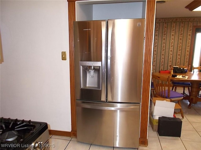 kitchen with light tile patterned floors and stainless steel appliances