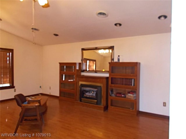 living room with hardwood / wood-style floors and ceiling fan