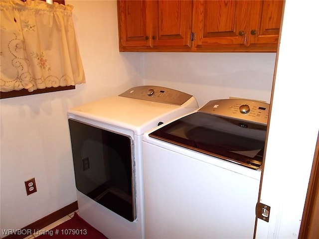 laundry room with cabinets and washing machine and clothes dryer