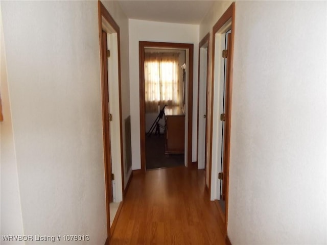 hallway with light hardwood / wood-style floors