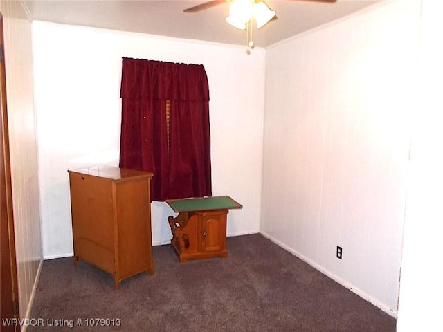 interior space featuring ceiling fan and dark colored carpet