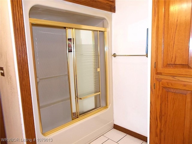 bathroom featuring tile patterned flooring and enclosed tub / shower combo