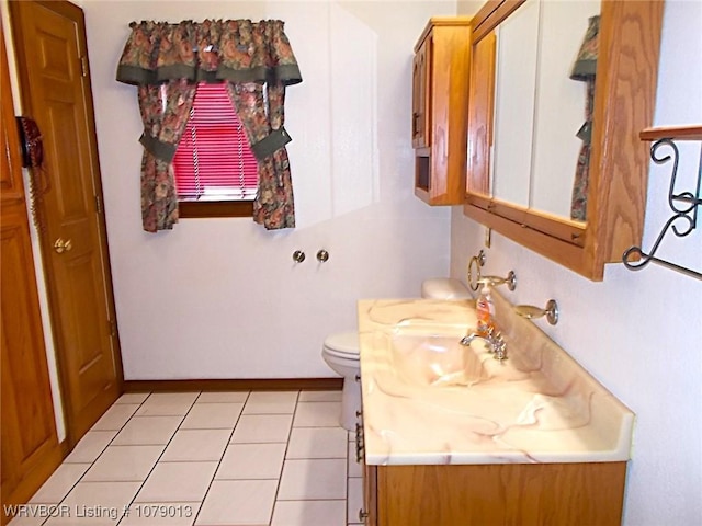 bathroom with vanity, tile patterned flooring, and toilet