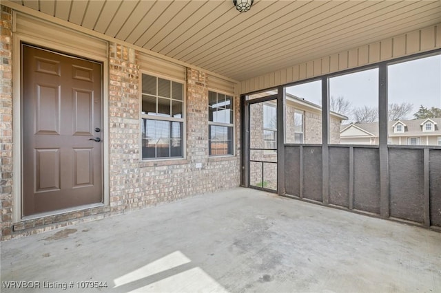 unfurnished sunroom featuring a wealth of natural light and wood ceiling