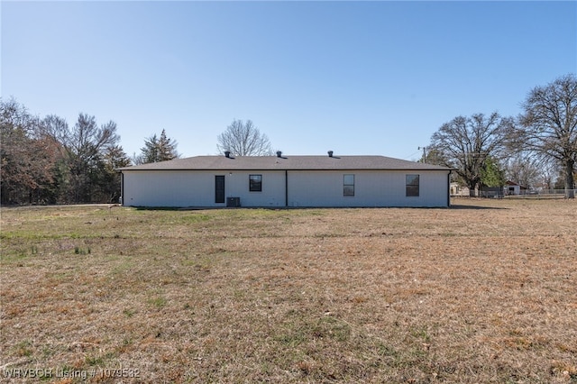 back of house featuring a yard and central AC