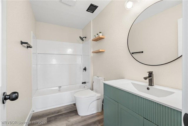 full bathroom with vanity, wood finished floors, visible vents, shower / washtub combination, and toilet