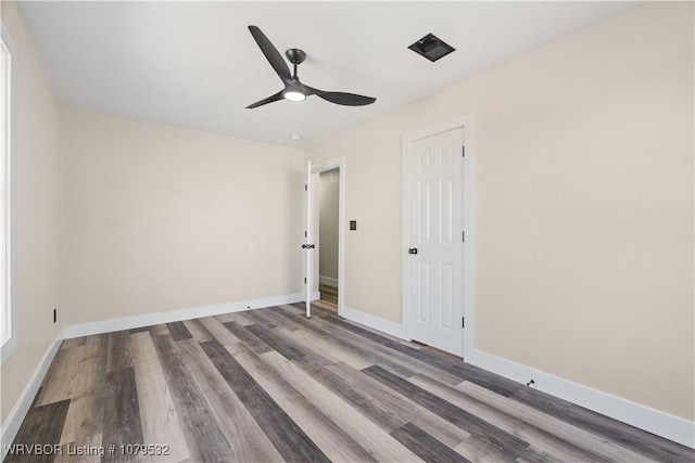 unfurnished bedroom featuring baseboards, wood finished floors, and a ceiling fan