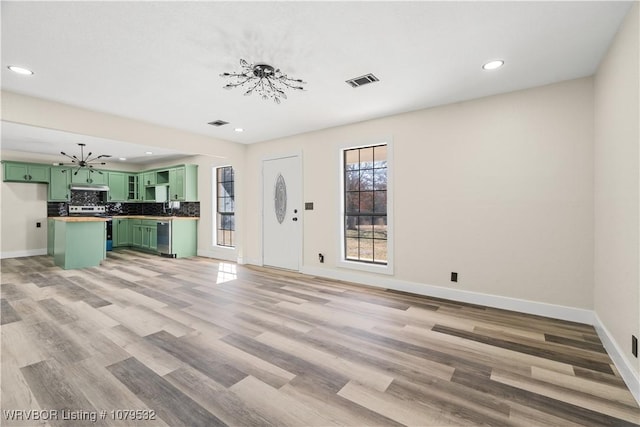 interior space featuring light wood-style floors, recessed lighting, baseboards, and visible vents