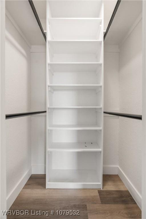 walk in closet featuring wood finished floors