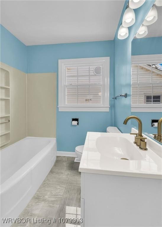 full bathroom with a bath, vanity, toilet, and baseboards