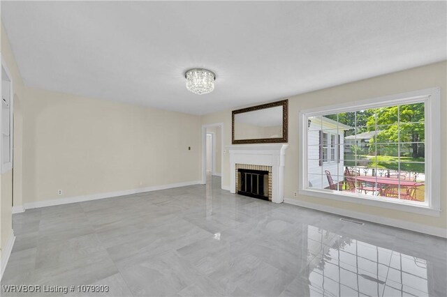 2105 S R St, Fort Smith, AR 72901 - living area with marble finish floor, a fireplace, baseboards, and a chandelier