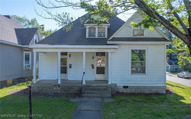 view of front of house with a porch, a front yard, and cooling unit