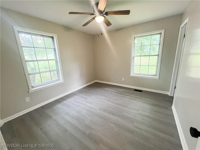 120 W Gary St, Greenwood, AR 72936 - empty room with plenty of natural light, dark wood-type flooring, and ceiling fan