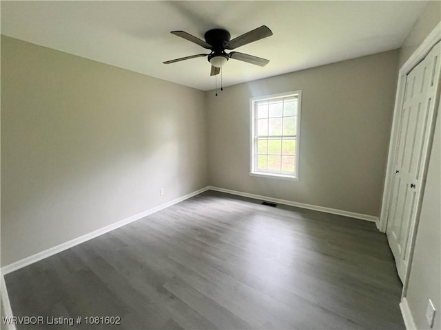 120 W Gary St, Greenwood, AR 72936 - unfurnished bedroom with dark wood finished floors, baseboards, and a closet
