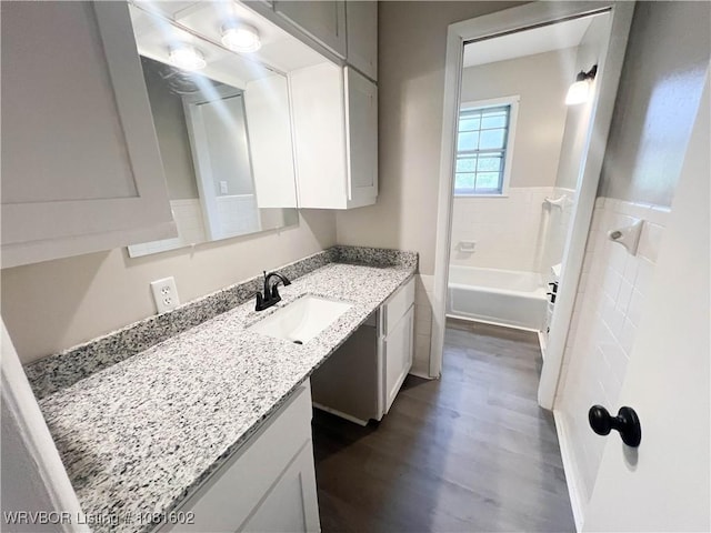 120 W Gary St, Greenwood, AR 72936 - bathroom featuring vanity, wood finished floors, and a tub
