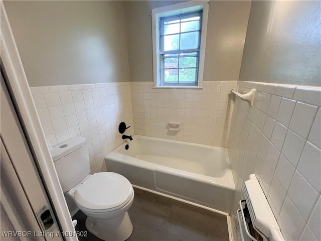 120 W Gary St, Greenwood, AR 72936 - bathroom with tile walls, toilet, a bath, wood finished floors, and a wainscoted wall