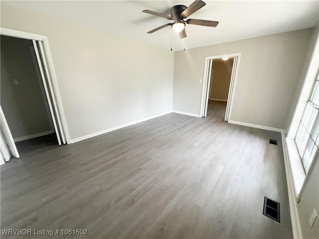 120 W Gary St, Greenwood, AR 72936 - unfurnished bedroom with dark wood-type flooring, baseboards, and a ceiling fan