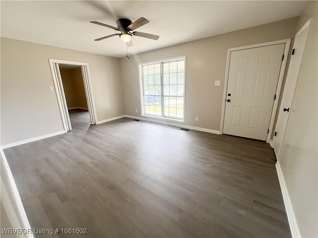 120 W Gary St, Greenwood, AR 72936 - unfurnished living room featuring dark wood-type flooring, ceiling fan, and baseboards