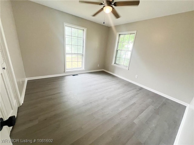 120 W Gary St, Greenwood, AR 72936 - empty room with a ceiling fan, dark wood-style flooring, and baseboards