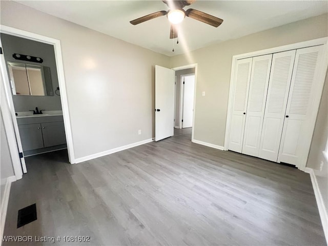 120 W Gary St, Greenwood, AR 72936 - unfurnished bedroom with wood finished floors, baseboards, and a closet