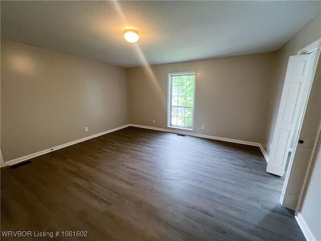 120 W Gary St, Greenwood, AR 72936 - empty room featuring baseboards and dark wood-style floors