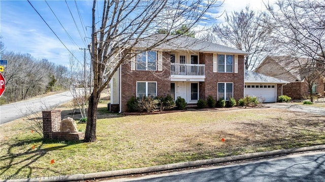 view of front of house with brick siding, a front lawn, concrete driveway, a garage, and a balcony