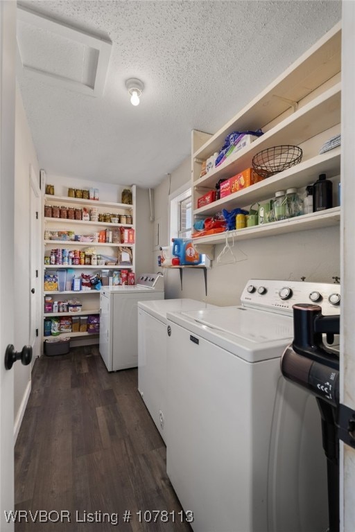 laundry area with a textured ceiling, dark hardwood / wood-style flooring, and separate washer and dryer