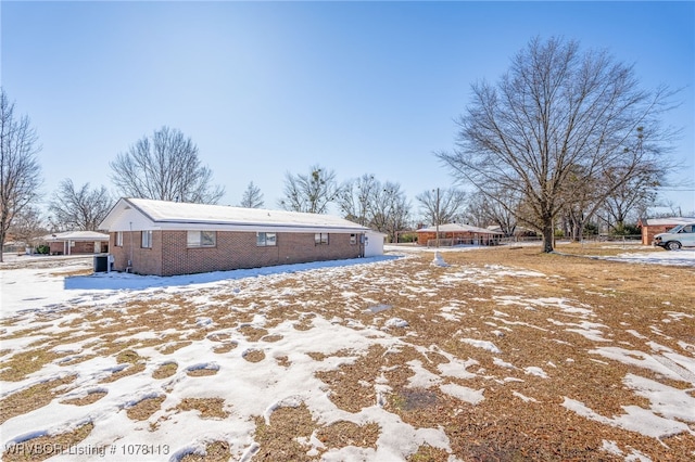 snow covered property featuring cooling unit