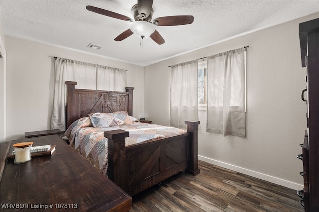 bedroom featuring ceiling fan, dark hardwood / wood-style flooring, and a textured ceiling