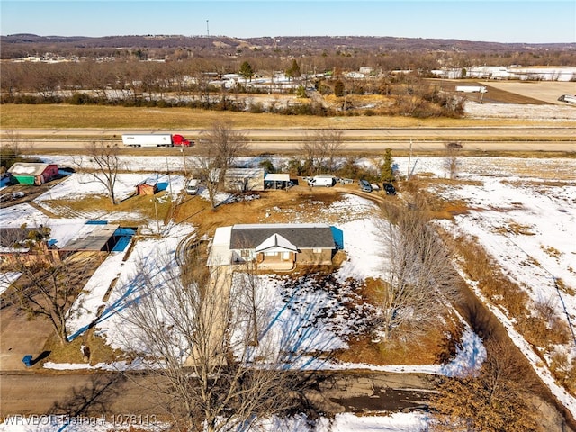 snowy aerial view featuring a rural view