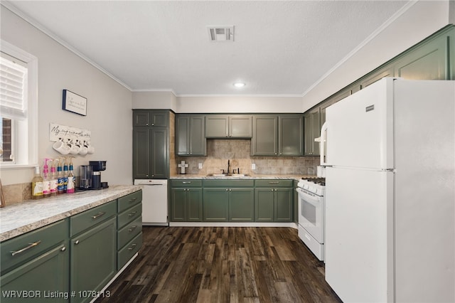 kitchen with decorative backsplash, white appliances, sink, green cabinetry, and dark hardwood / wood-style floors