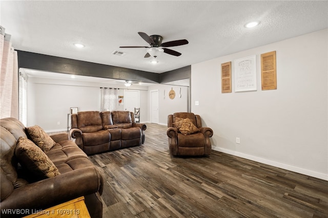 living room featuring a textured ceiling, ceiling fan, and dark hardwood / wood-style floors