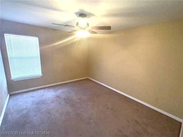 unfurnished room with carpet, a ceiling fan, and baseboards