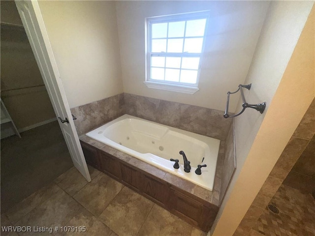 bathroom with a tile shower and a jetted tub