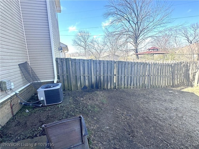 view of yard featuring fence and central air condition unit