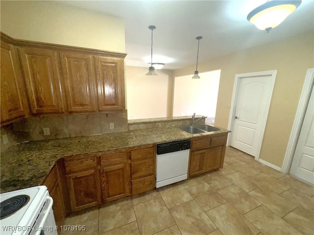 kitchen with white appliances, a sink, decorative backsplash, brown cabinetry, and decorative light fixtures