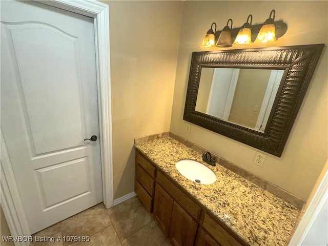 bathroom with tile patterned flooring, vanity, and baseboards