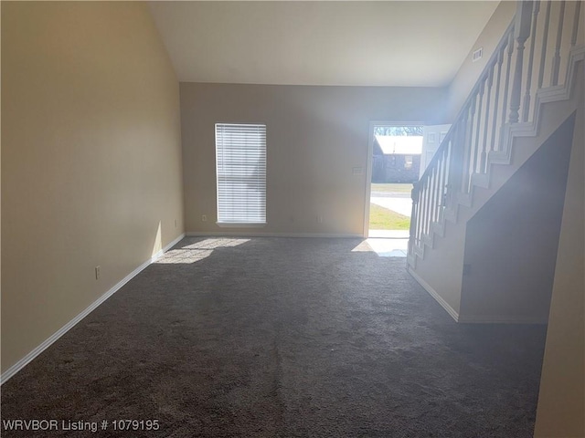 unfurnished room featuring stairs, carpet flooring, and baseboards