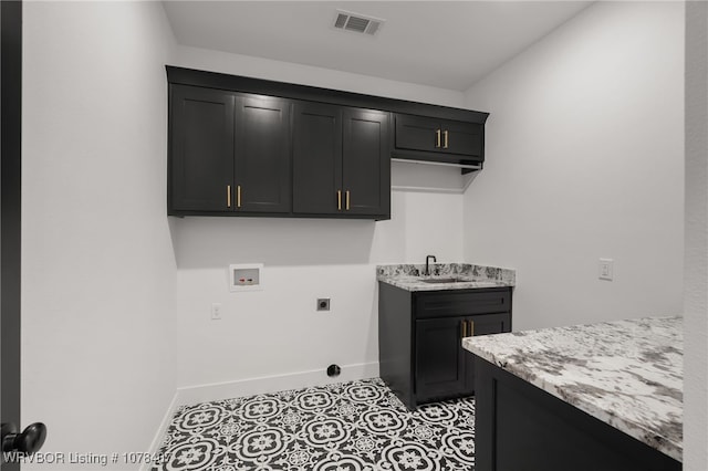 laundry area featuring light tile patterned floors, hookup for an electric dryer, hookup for a washing machine, cabinets, and sink