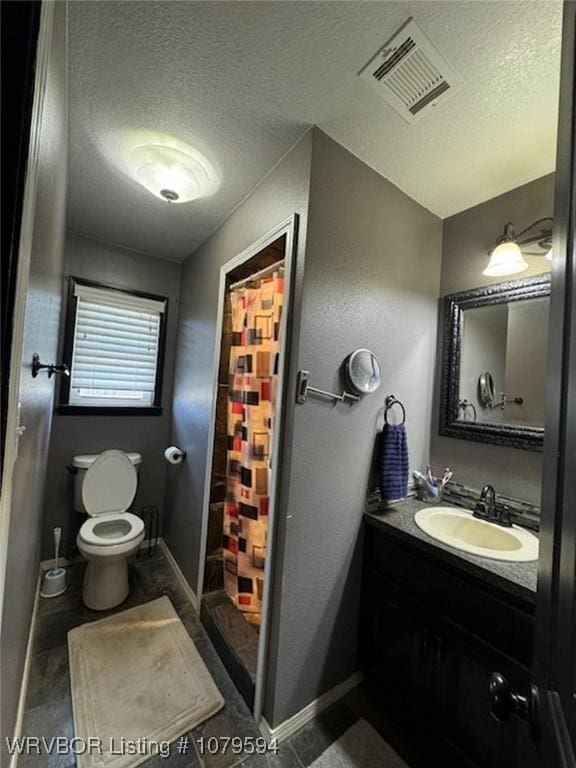 bathroom with vanity, visible vents, a textured ceiling, curtained shower, and toilet