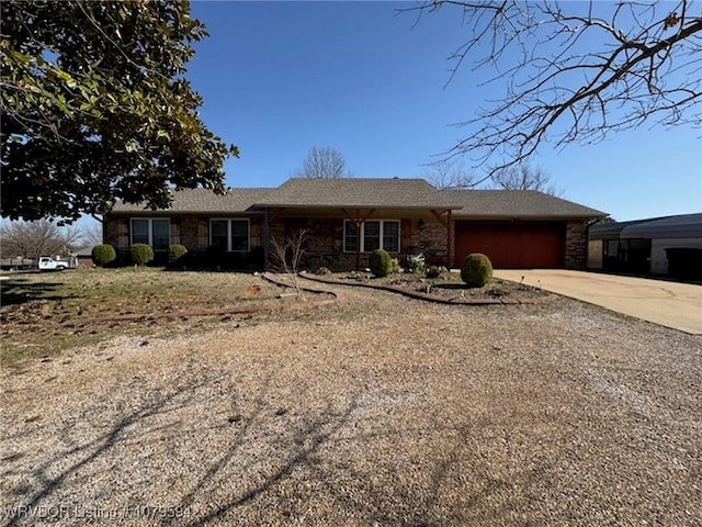 ranch-style house with an attached garage and concrete driveway