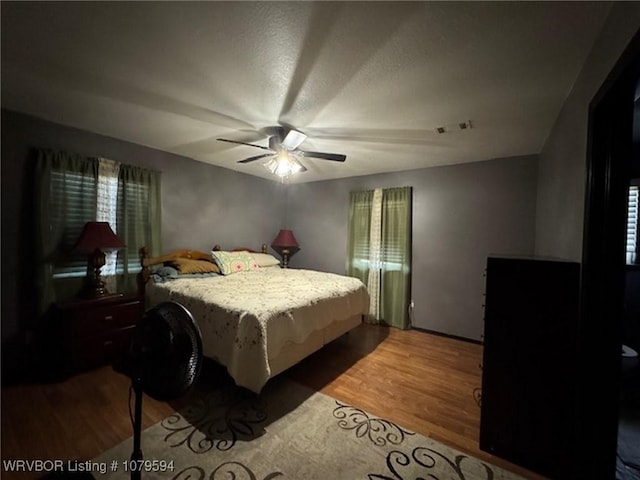 bedroom with wood finished floors and a ceiling fan