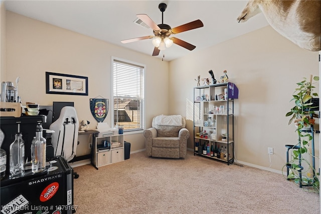 office area featuring light carpet, ceiling fan, and baseboards