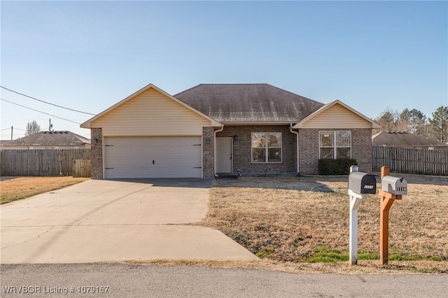 ranch-style home featuring brick siding, a shingled roof, concrete driveway, an attached garage, and fence