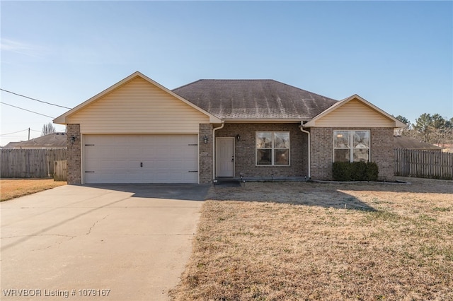 single story home with brick siding, an attached garage, fence, driveway, and a front lawn