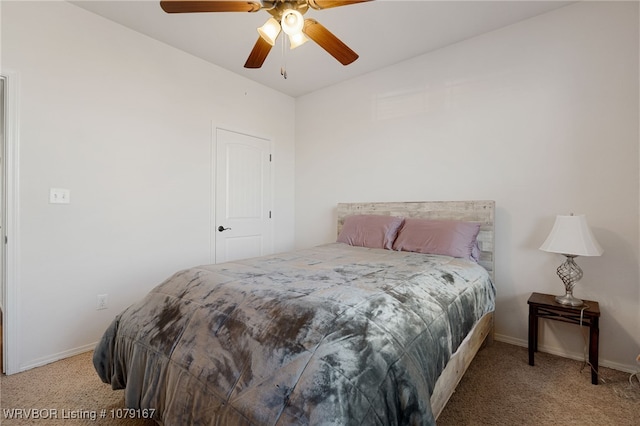 bedroom with light carpet, ceiling fan, and baseboards