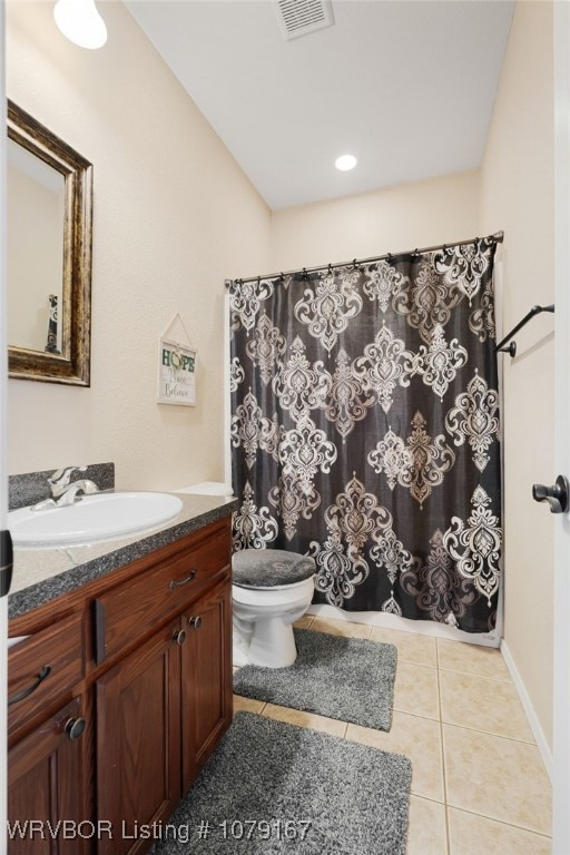 full bath with toilet, vanity, visible vents, and tile patterned floors