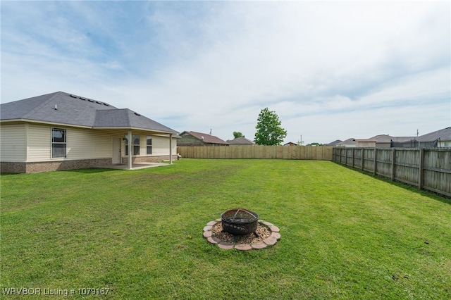 view of yard with an outdoor fire pit, a patio area, and a fenced backyard