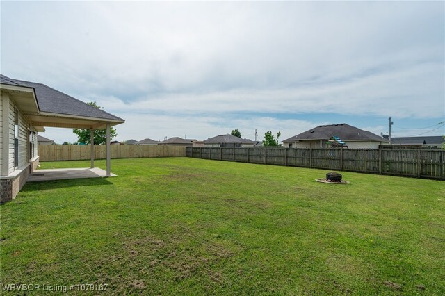 view of yard with an outdoor fire pit, a patio, and a fenced backyard